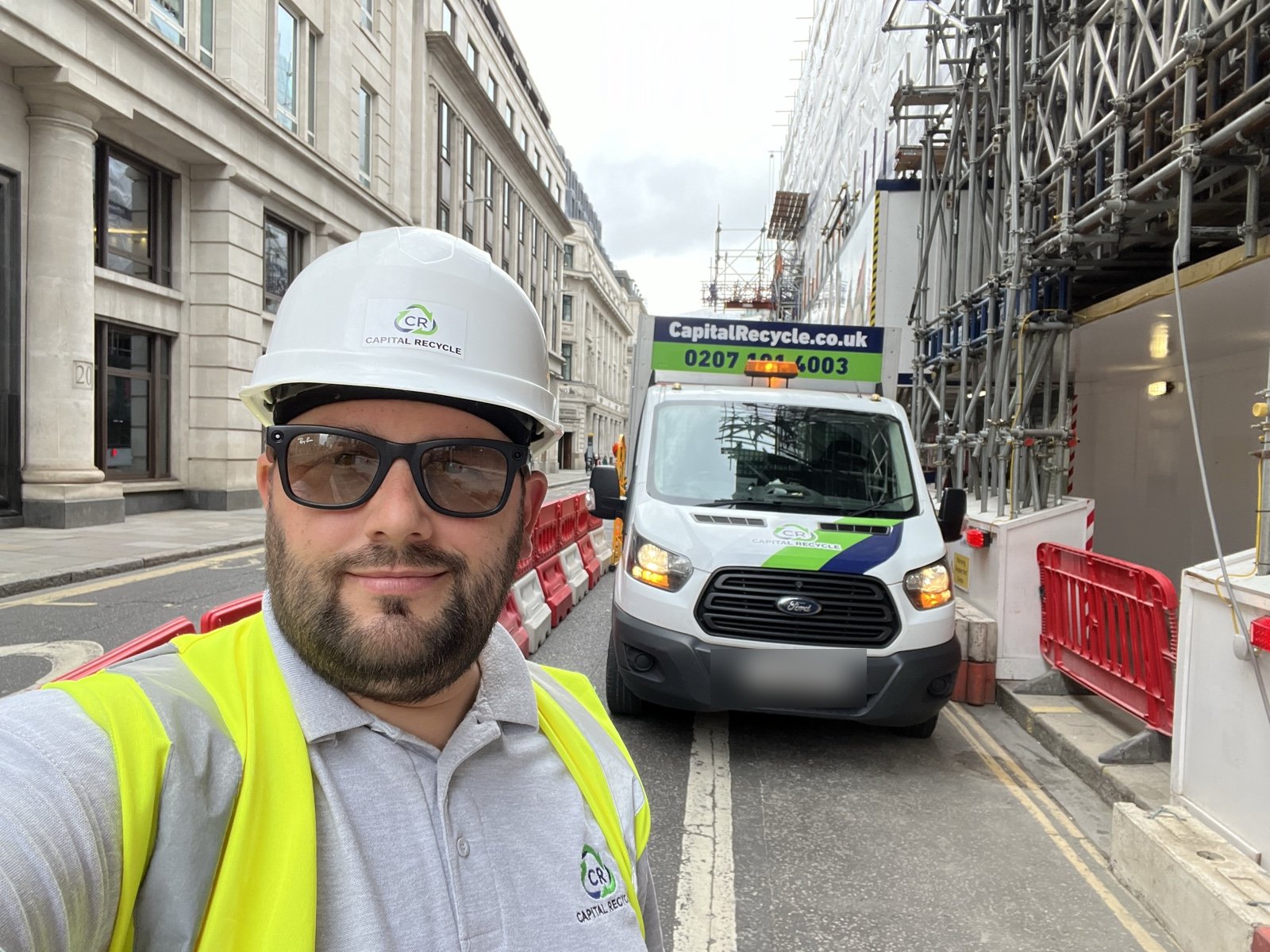 G&eacute;za Gr&ouml;ller, founder of Capital Recycle Ltd, in a hard hat and hi-vis in front of a Capital Recycle caged tipper in the City of London